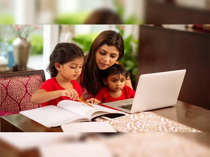 Parents reading a picture book with their two children at home