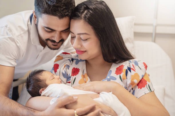 A mother tenderly holding her newborn in soft warm light